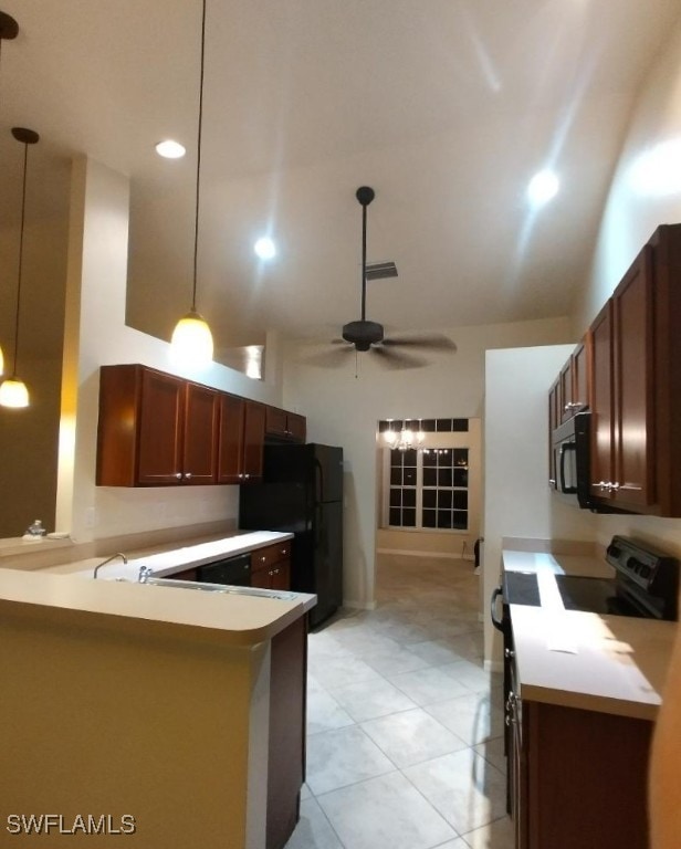 kitchen featuring black appliances, ceiling fan, light countertops, and decorative light fixtures