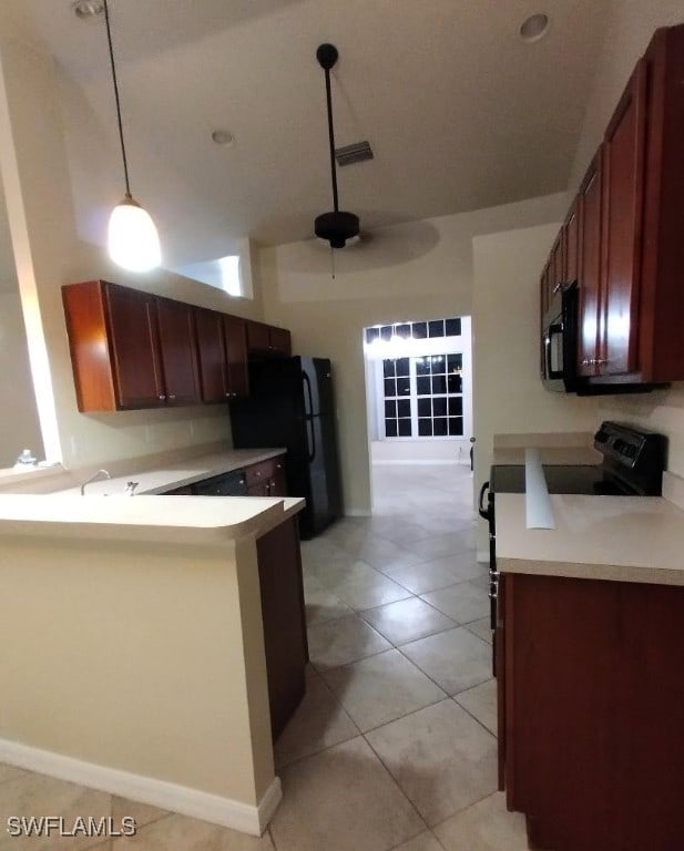 kitchen featuring light tile patterned floors, visible vents, light countertops, a peninsula, and black appliances