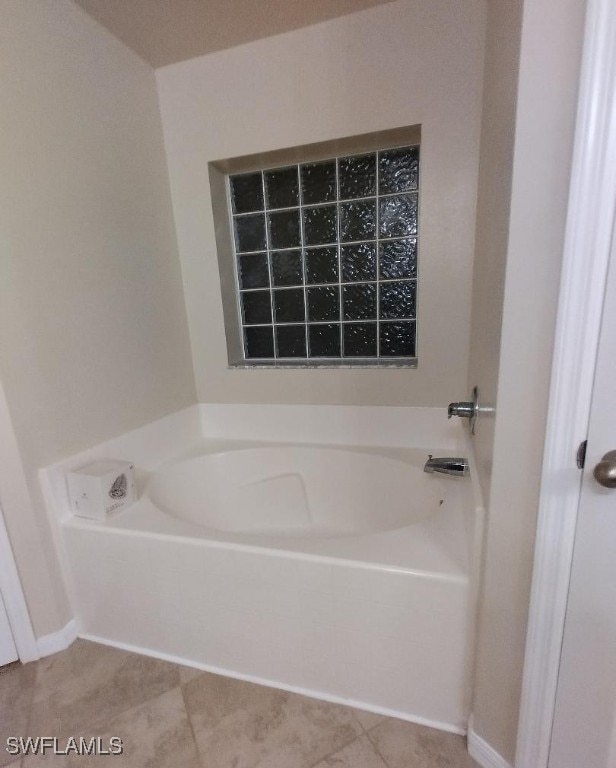 full bath with a bath and tile patterned floors