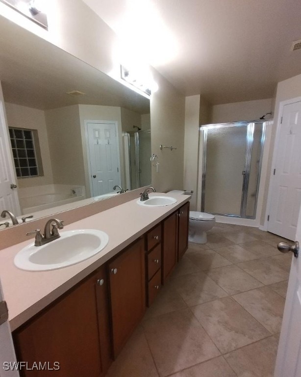 full bathroom featuring double vanity, a stall shower, and a sink