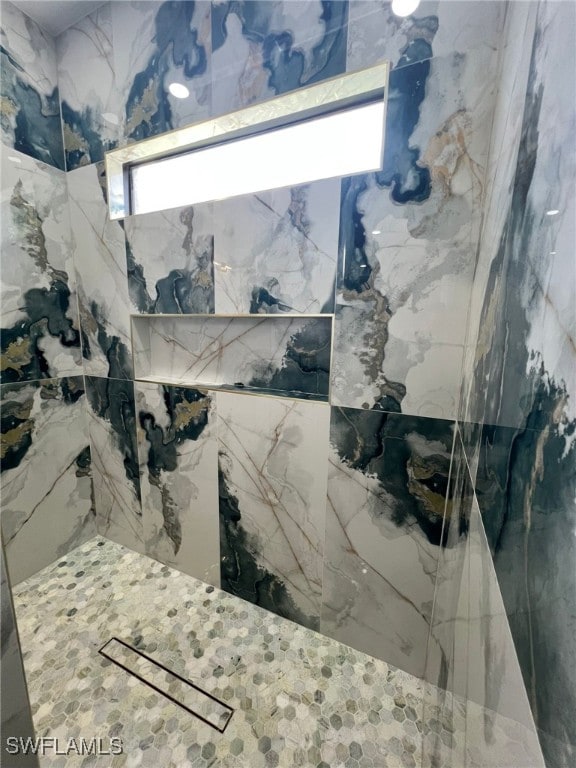 1104 Alaska Ave, Lehigh Acres, FL 33971 - bathroom featuring a marble finish shower and plenty of natural light