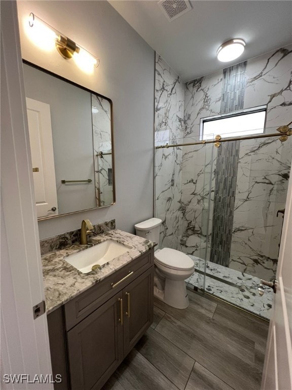 1104 Alaska Ave, Lehigh Acres, FL 33971 - bathroom with a marble finish shower, vanity, and wood finished floors