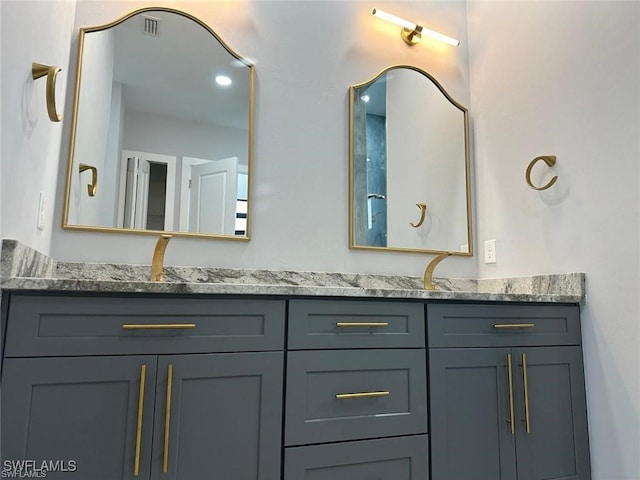 bathroom with a sink and double vanity