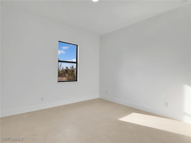 spare room featuring baseboards