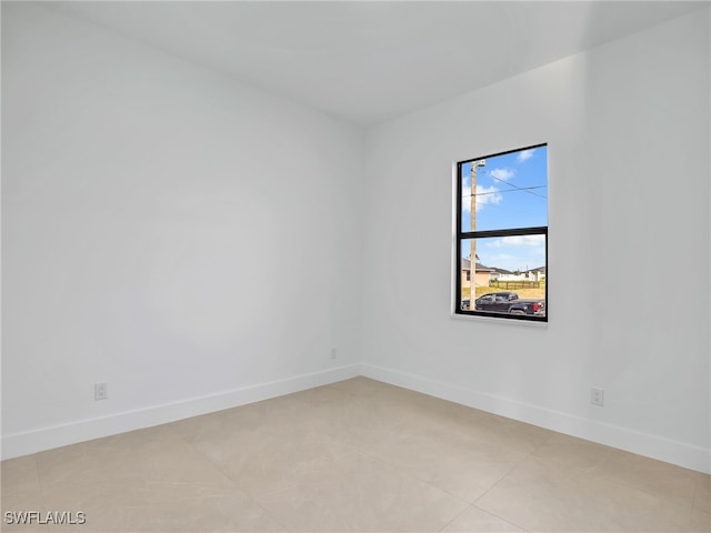 empty room featuring baseboards