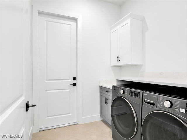 1612 NW 9th Ave, Cape Coral, FL 33993 - laundry area featuring light tile patterned floors, independent washer and dryer, cabinet space, and baseboards