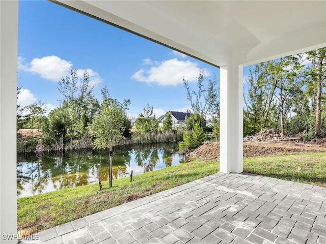 view of patio with a water view