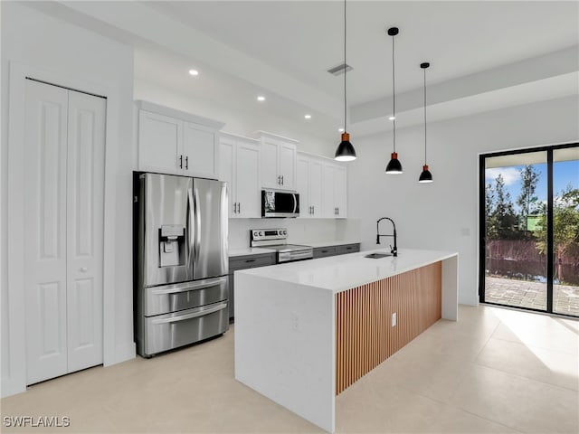 kitchen featuring recessed lighting, a sink, white cabinetry, appliances with stainless steel finishes, and pendant lighting