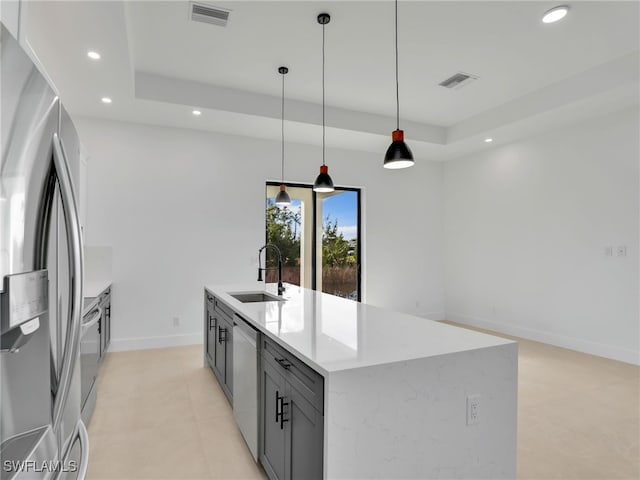 kitchen with stainless steel appliances, a raised ceiling, visible vents, and a sink