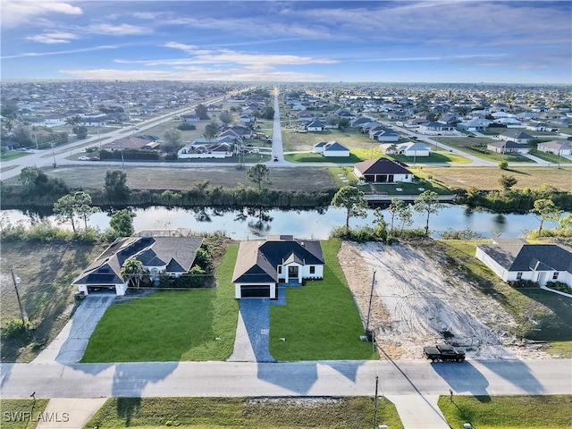 drone / aerial view with a residential view and a water view