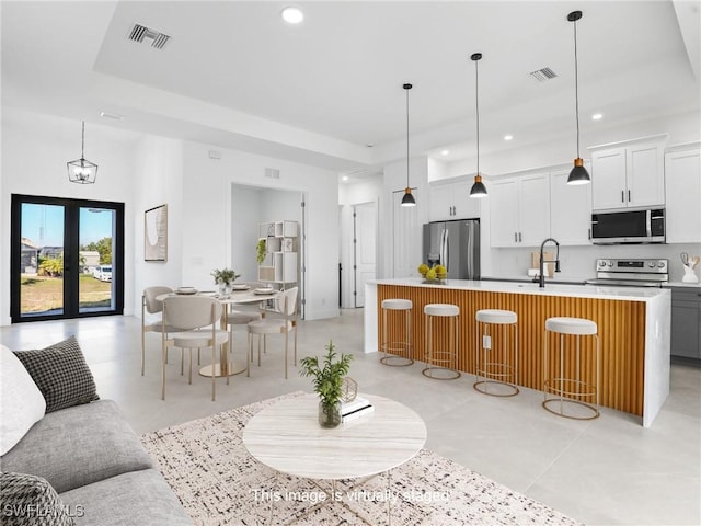 1612 NW 9th Ave, Cape Coral, FL 33993 - kitchen featuring visible vents, a kitchen island with sink, appliances with stainless steel finishes, and light countertops
