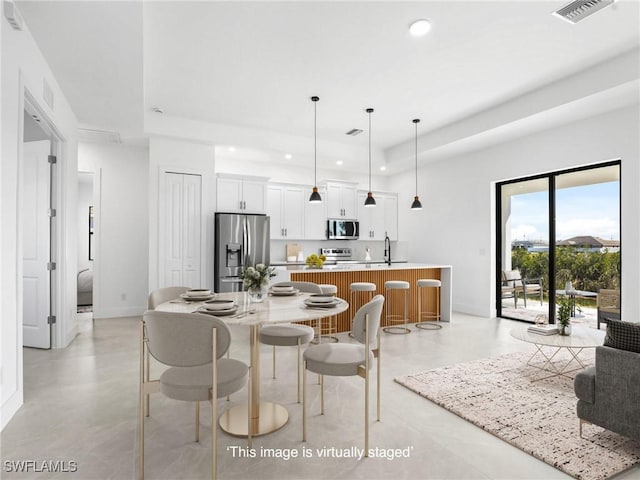 1612 NW 9th Ave, Cape Coral, FL 33993 - dining space with recessed lighting, visible vents, finished concrete flooring, and a raised ceiling