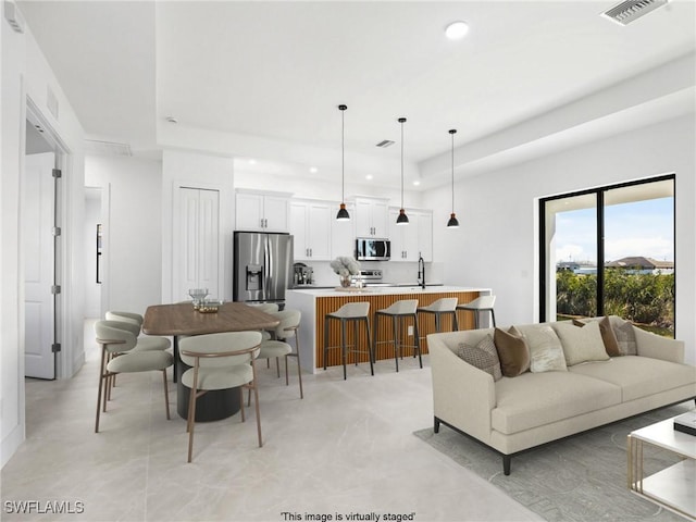 1612 NW 9th Ave, Cape Coral, FL 33993 - living area featuring a raised ceiling, visible vents, and recessed lighting