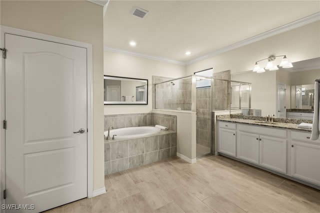 full bathroom with a garden tub, vanity, visible vents, a stall shower, and crown molding