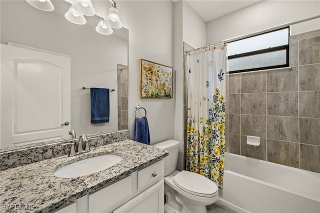 bathroom with a notable chandelier, shower / tub combo with curtain, vanity, and toilet