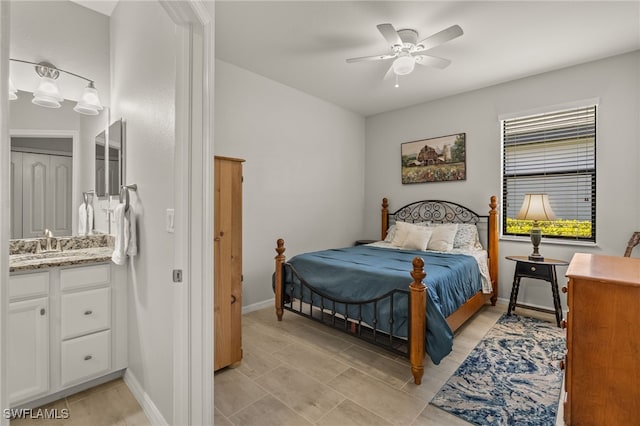 bedroom with ceiling fan, a sink, and baseboards