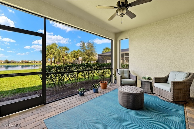 unfurnished sunroom with a water view, a healthy amount of sunlight, and a ceiling fan