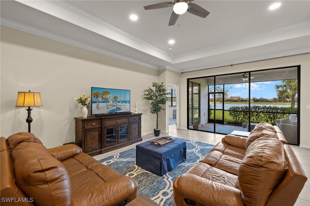 living room featuring ornamental molding, a tray ceiling, tile patterned flooring, and recessed lighting