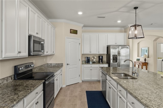 kitchen featuring stainless steel appliances, white cabinetry, a sink, and ornamental molding