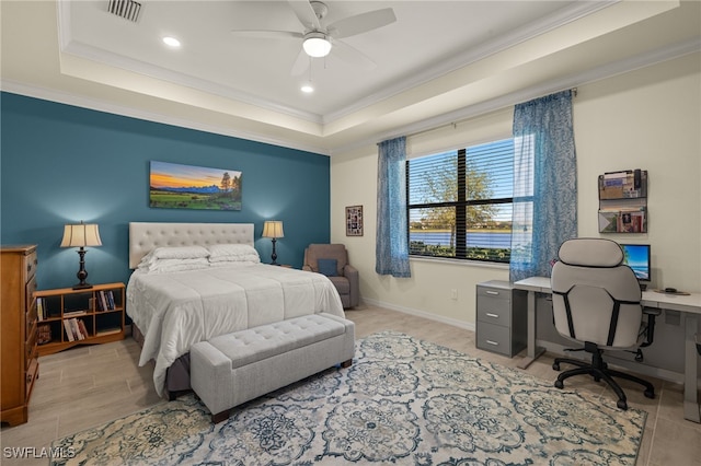 bedroom featuring ornamental molding, a tray ceiling, visible vents, and baseboards