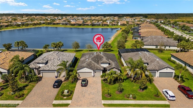 birds eye view of property featuring a water view and a residential view