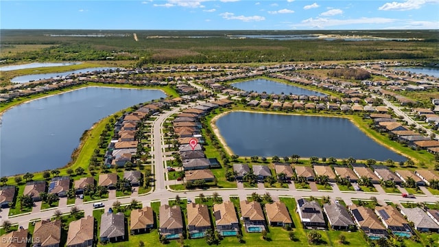 bird's eye view with a water view and a residential view