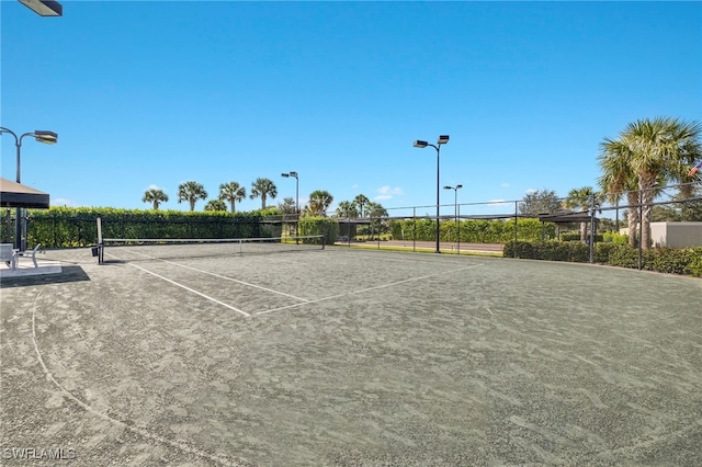 view of tennis court with fence