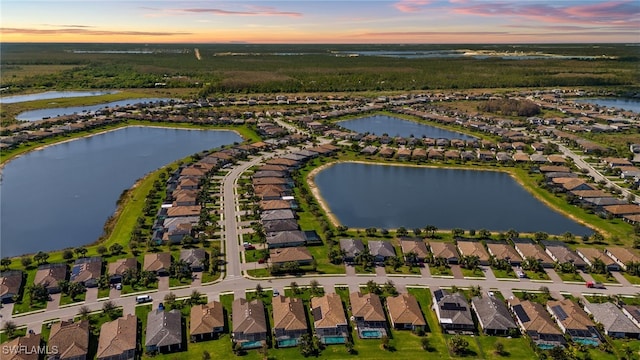 birds eye view of property featuring a residential view and a water view