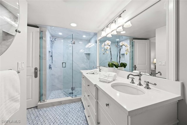 bathroom with double vanity, a stall shower, a sink, and tile patterned floors