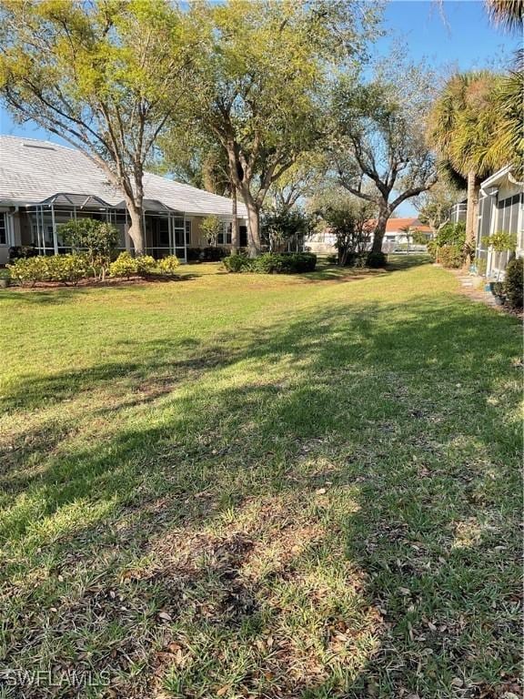 view of yard with a lanai