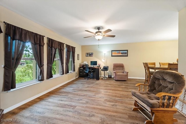 office area featuring a ceiling fan, baseboards, and wood finished floors