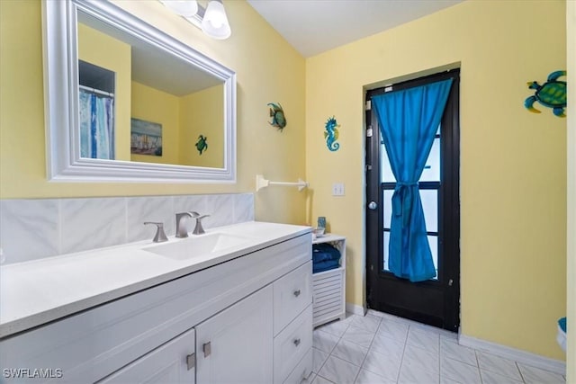 bathroom featuring vanity and baseboards