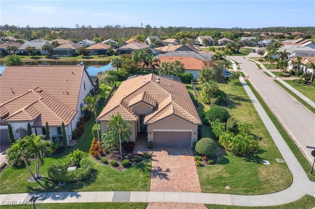 birds eye view of property featuring a residential view and a water view