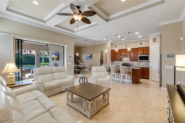 living room with light tile patterned floors, crown molding, and a ceiling fan