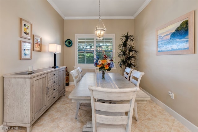 dining room featuring crown molding, light tile patterned floors, baseboards, and a chandelier