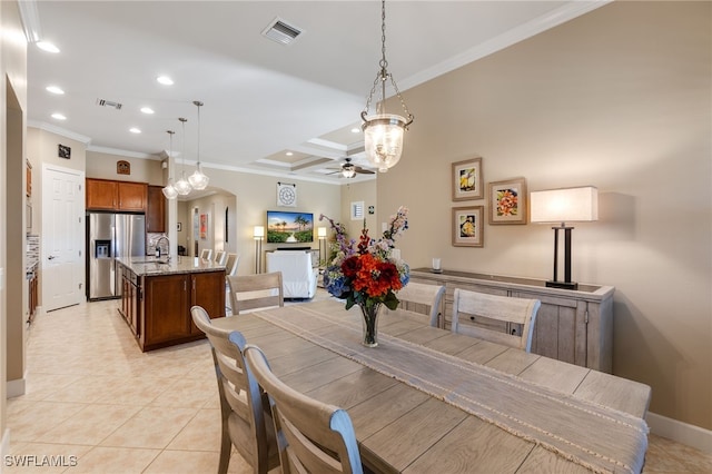 dining room featuring light tile patterned flooring, a ceiling fan, visible vents, and ornamental molding