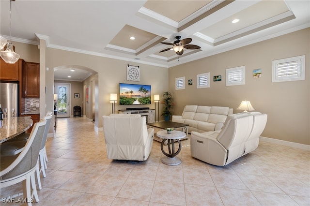 living area with ornamental molding, coffered ceiling, arched walkways, light tile patterned flooring, and baseboards