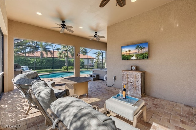 view of patio with glass enclosure, an outdoor pool, a hot tub, and ceiling fan