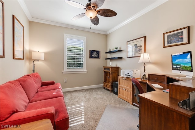 home office featuring light carpet, a ceiling fan, baseboards, and ornamental molding