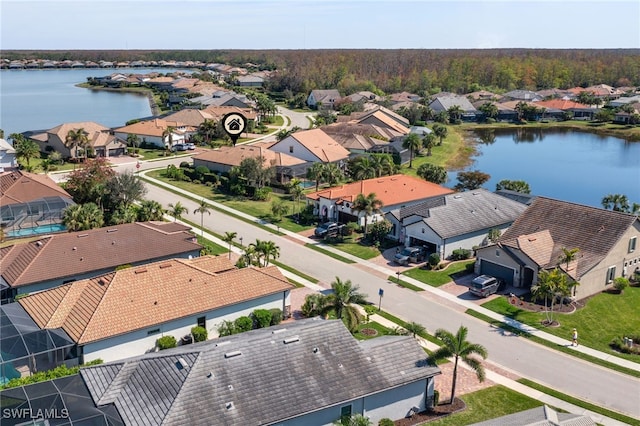 drone / aerial view with a residential view and a water view