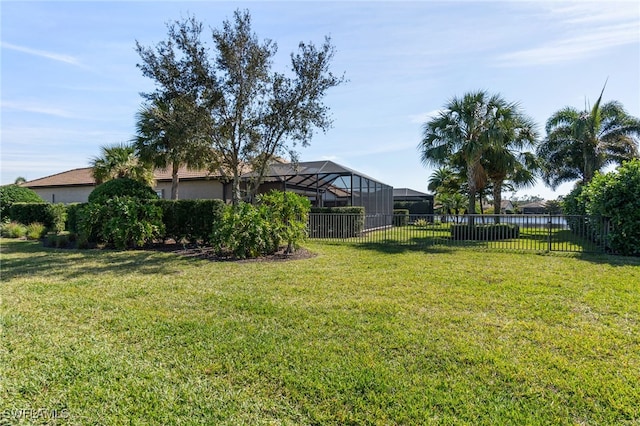 view of yard featuring a lanai and fence