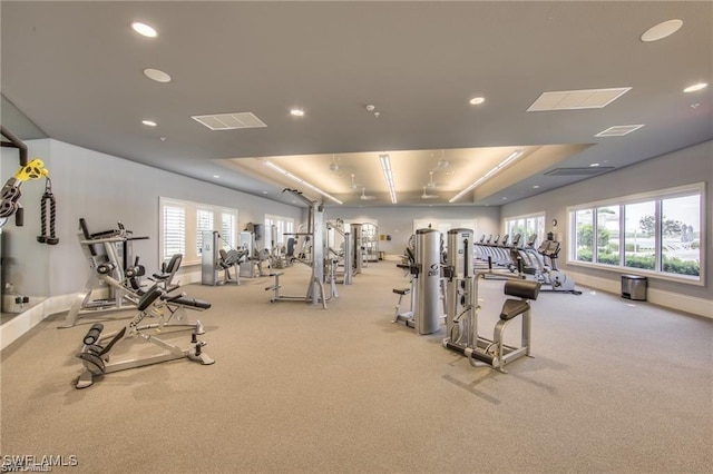 gym featuring recessed lighting, visible vents, a raised ceiling, and carpet floors