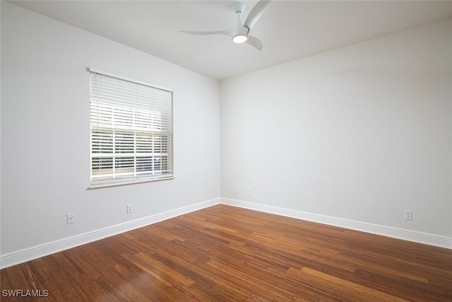 spare room with wood finished floors, baseboards, and ceiling fan