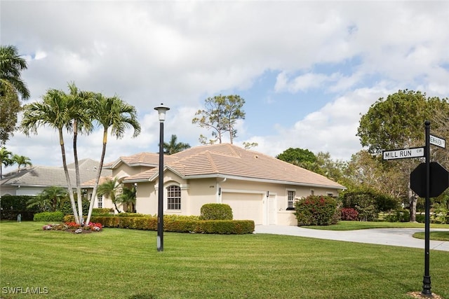 view of front of home with a garage, concrete driveway, a front lawn, and a tiled roof