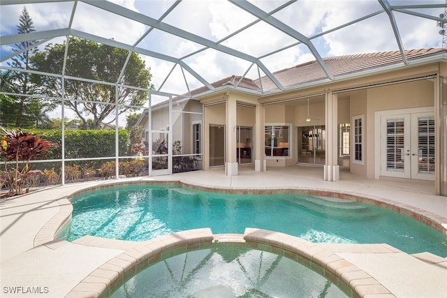 view of pool with french doors, a patio area, and a pool with connected hot tub