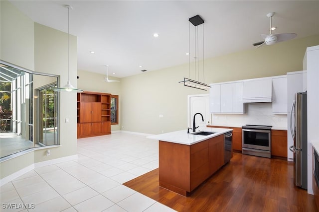 kitchen featuring a sink, modern cabinets, tasteful backsplash, and stainless steel appliances