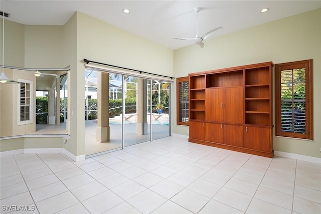 empty room with light tile patterned floors, recessed lighting, baseboards, and ceiling fan