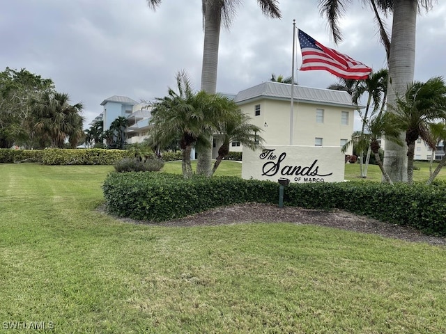 community sign featuring a yard