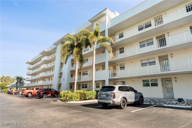 view of building exterior featuring uncovered parking