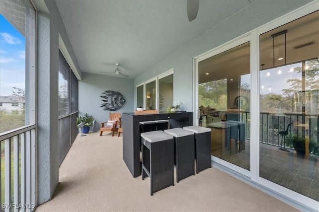 sunroom with a ceiling fan